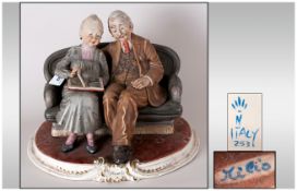 Capodimonte Large and Early Figure Group ' Old Couple Looking Through a Photo Album  Signed Milio.