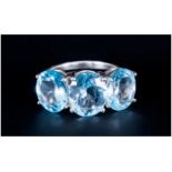 Sky Blue Topaz Three Stone Ring, the central oval cut topaz being 4.5cts, with the similar stones to