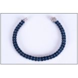 Blue Sapphire and Diamond Bracelet, a double row of rich blue, oval cut sapphires, totalling a
