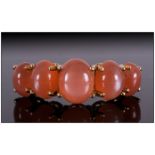 Peach Moonstone Five Cabochon Ring, the largest oval cut cabochon to the centre, measuring 2cts,