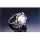 18ct Gold Dress Ring Set With A Central Split Pearl And 6 Diamond Chips In A Flowerhead Setting,