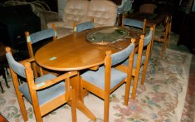 Oval Light Wooden Table With Six Chairs.