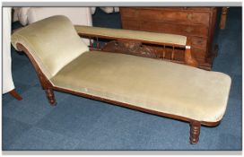 An Edwardian Upholstered Walnut Framed Parlour Chaise Longue covered in a lime coloured velour, with
