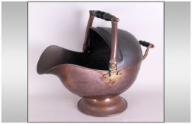 Early Victorian Copper Helmet Shaped Coal Scuttle on a plinth. With a loop handle with wooden grip.