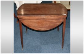 A Georgian Mahogany Pembroke Table with an oval shaped top, Flat sided with one drawer, on square