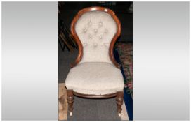 Victorian Walnut Framed Nursing Chair with a spoon shaped back, upholstered seat & back on turned