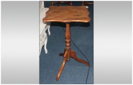 Early Victorian Elm Shaped Top Centre Table on a turned baluster column, on shaped three cabriole