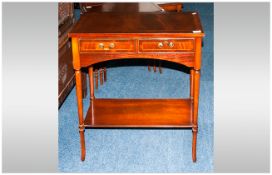 Reproduction Mahogany Sheraton Style Two Drawer Side Table with an inlaid cross banded top and round