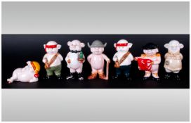 Seven Piggies Porcelain Figures. Standing In Various Poses. Approx 4 Inches High.