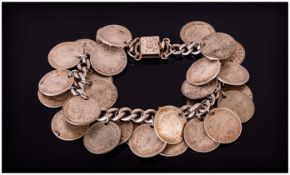 A Silver Curb Bracelet loaded with 26 silver three pences, assorted dates, marked silver. 55 grams.