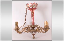An Unusual Venetian Red Overlaid Chandelier with a central column, with a gilded decoration, with