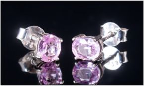 Pink Sapphire Stud Earrings, two solitaire oval cut pink sapphires totalling .75ct, set in rhodium