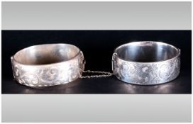 A Pair Of Good Quality Silver Hinged Bangles with engraved floral decoration. Hallmarked