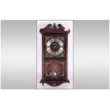 Reproduction Brass Faced Wall Clock with exposed pendulum, with a glazed front. Makers name,
