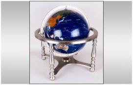 World Gem Globe, tilt and swivel, set in four legged white metal stand