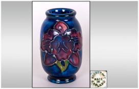 Moorcroft - Early Miniature / Samplers Vase ' Orchid ' Design on Blue Ground. 2 Inches High.