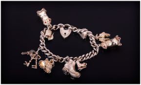 Silver Charm Bracelet Loaded With 9 Charms, Complete With Padlock And Saftey Chain.