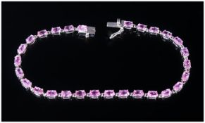 Pink Sapphire Tennis Bracelet, a row of oval cut sapphires in one of the rarest colours of sapphire,