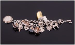 A Vintage Silver Charm Bracelet loaded with 19 charms, fully hallmarked. 62 grams.