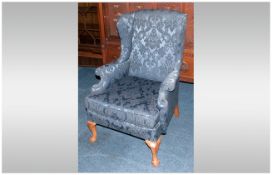 A Queen Anne Style Wing Arm Chair with a loose cushion seat on scrolling arms and Queen Anne Legs,