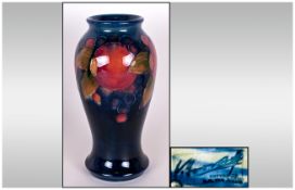 William Moorcroft Signed Shaped Vase. c.1920's. Pomegranates and Berries on Blue Ground.