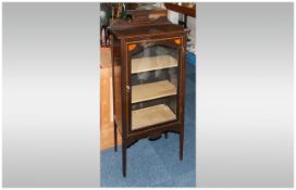 An Edwardian Inlaid Single Glazed Door Display Cabinet with a shaped back top rail with two interior