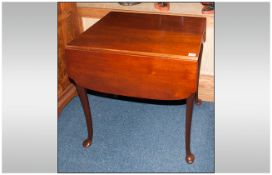 A Mahogany Queen Anne Style Drop Leaf Pembroke Style Table with shaped side flaps and one single