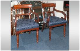 Pair of Regency Mahogany Scroll Arm Chairs with a shaped top rail, with a carved acanthus leaf