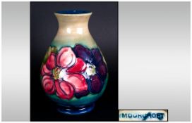Moorcroft Ovoid Shaped Vase ' Clematis ' Design on Blue Ground and Blue Base. Stands 7.25 Inches