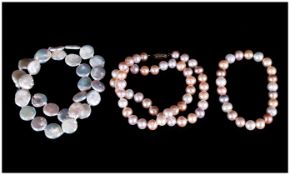 Two Various Freshwater Pearl Necklaces comprising a strand of white coin pearls and a strand of