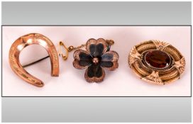 Victorian and Later Brooches, three comprising one oval, gold plated with oval, faceted dark