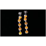 Orange Ethiopian Opal Long Drop Earrings, each earring comprising five round cut cabochons, bezel