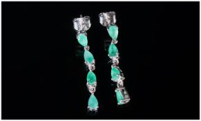 Emerald Articulated Drop Earrings, each earring comprising four pear cut emeralds, the top one