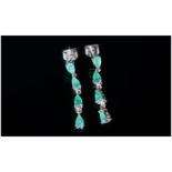 Emerald Articulated Drop Earrings, each earring comprising four pear cut emeralds, the top one