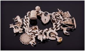 Heavy Silver Charm Bracelet Loaded With 19 Charms, Complete With Padlock And Safety Chain. Weight