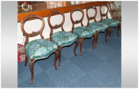 A Set of Five Victorian Carved Walnut Balloon Back Chairs
