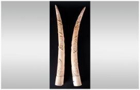 An Antique Pair Of Carved Ivory Tusks, Decorated with raised images of wild animals. Weight