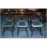 A Set of Dark Stained Spindle Back Chairs with shaped backs.