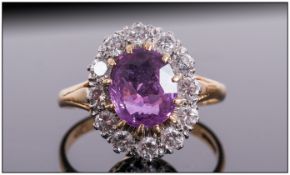 Ladies 18ct Gold Gallery Mounted Diamond and Amethyst Cluster Ring. The Central Faceted Amethyst
