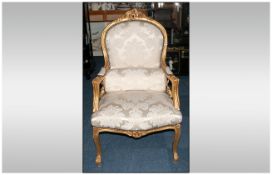 French Carved Gilt Wood Armchair with shaped padded arms, carved floral top rail with upholstered