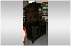 Traditional Priory Stained Oak Welsh Dresser with a shaped dome top. With plate rack on a cupboard