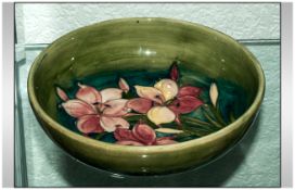 William Moorcroft Signed Footed Bowl ' Orchids ' Pattern on Green Ground. c.1930's. 8.75 Inches