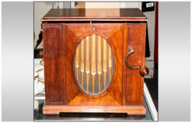 Hand Cranked Barrel Organ, playing 8 Airs. Simulated Organ Pipes to the front in an oval panel. With