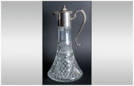 An Early 20th Century Silver Plated Topped Cut Glass Claret Jug with Fan Star Base. Stands 11.5