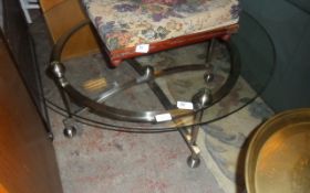 Large Circular Glass Coffee Table with Shiny Metal Legs.