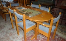 Wooden Oval Table with 6 Wooden Blue Cushioned Chairs.