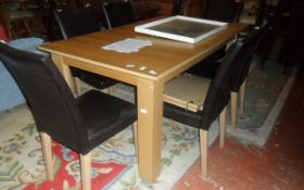 Modern Light Wooden Table with 6 Dark Leather Matching Chairs.