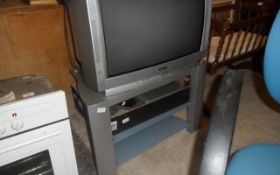 TV and TV Stand and Box with Video Player, Free View Box and Assorted Remotes.