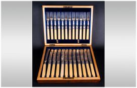 An Edwardian Boxed 24 Piece Set of Silver Plated Fish Knives and Forks. 12 Forks and 12 Knives