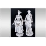 Pair Of German 19th Century Porcelain Figures of an elegant lady holding flowers in her hands,